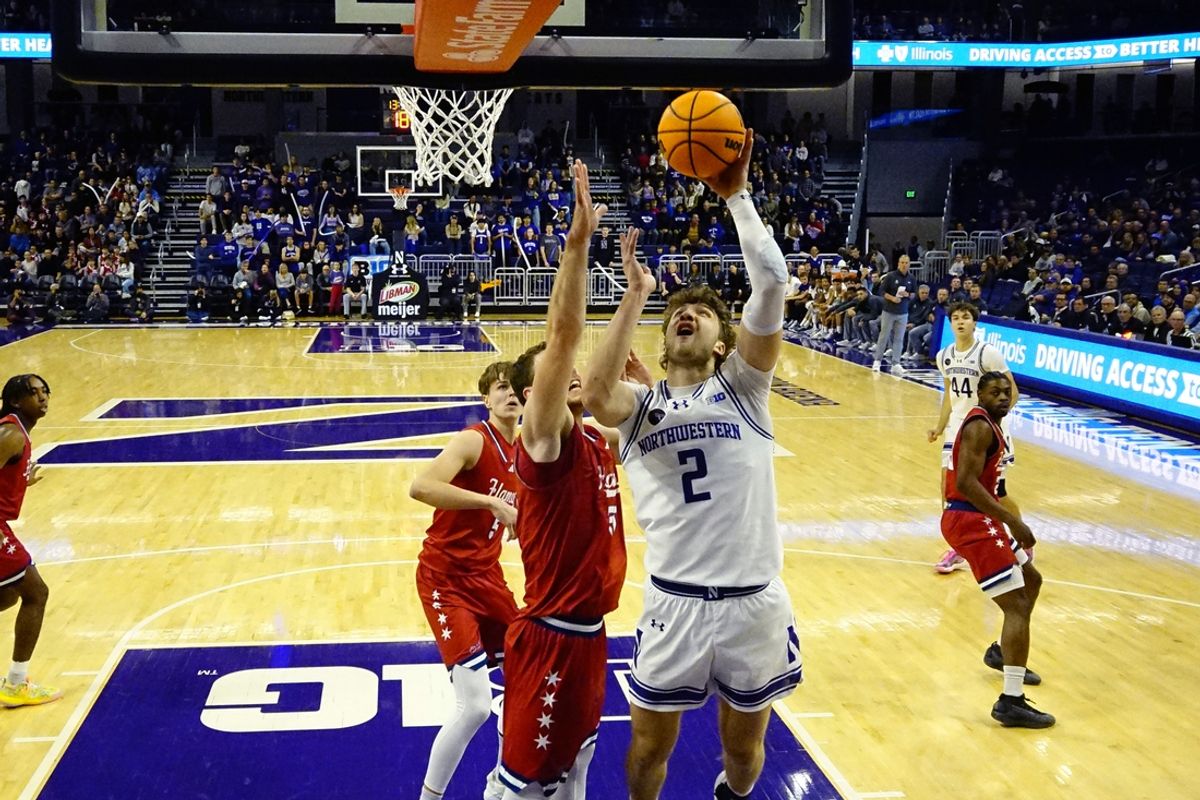 Nov 12, 2024; Evanston, Illinois, USA; Illinois-Chicago Flames forward Filip Skobalj (50) defends Northwestern Wildcats forward Nick Martinelli (2) during the first half at Welsh-Ryan Arena. Mandatory Credit: David Banks-Imagn Images