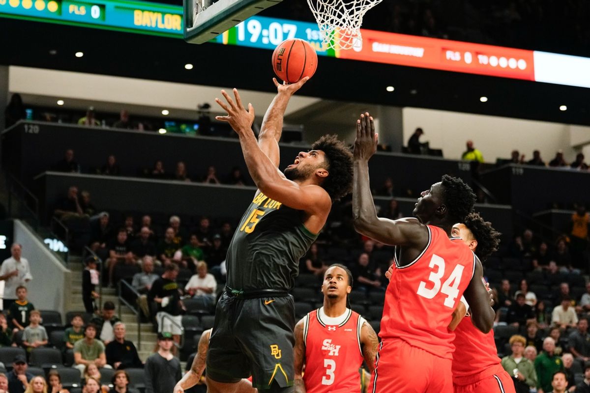 Nov 12, 2024; Waco, Texas, USA;  Baylor Bears forward Norchad Omier (15) scores a layup against Sam Houston State Bearkats forward Kalifa Sakho (34) during the first half at Paul and Alejandra Foster Pavilion. Mandatory Credit: Chris Jones-Imagn Images