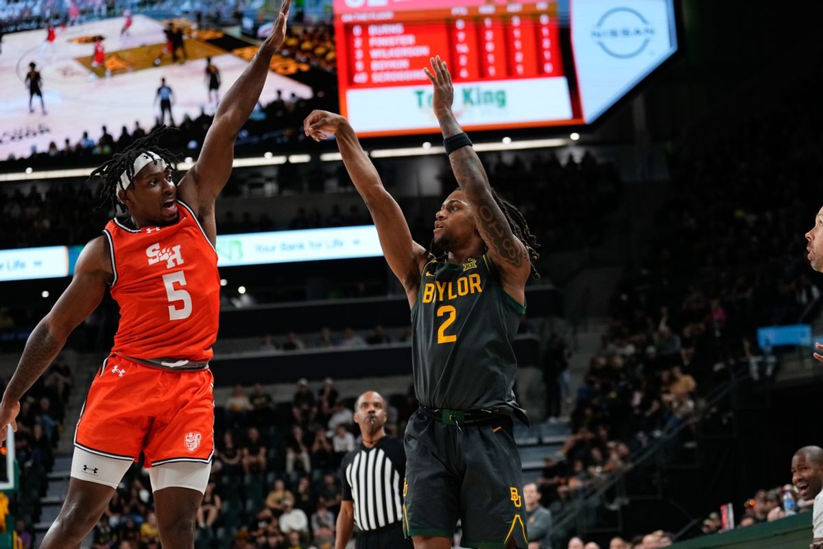 Nov 12, 2024; Waco, Texas, USA;  Baylor Bears guard Jayden Nunn (2) scores a three-point basket as Sam Houston State Bearkats guard Marcus Boykin (5) defends during the first half at Paul and Alejandra Foster Pavilion. Mandatory Credit: Chris Jones-Imagn Images