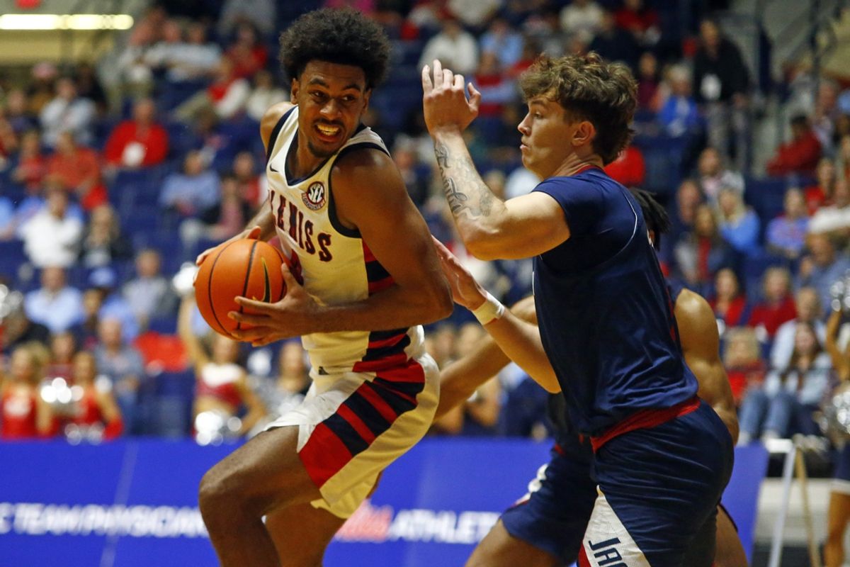 Nov 12, 2024; Oxford, Mississippi, USA; Mississippi Rebels forward Jaemyn Brakefield (4) spins toward the basket as South Alabama Jaguars forward Elijah Ormiston (3) defends during the first half at C.M. 'Tad' Smith Coliseum. Mandatory Credit: Petre Thomas-Imagn Images