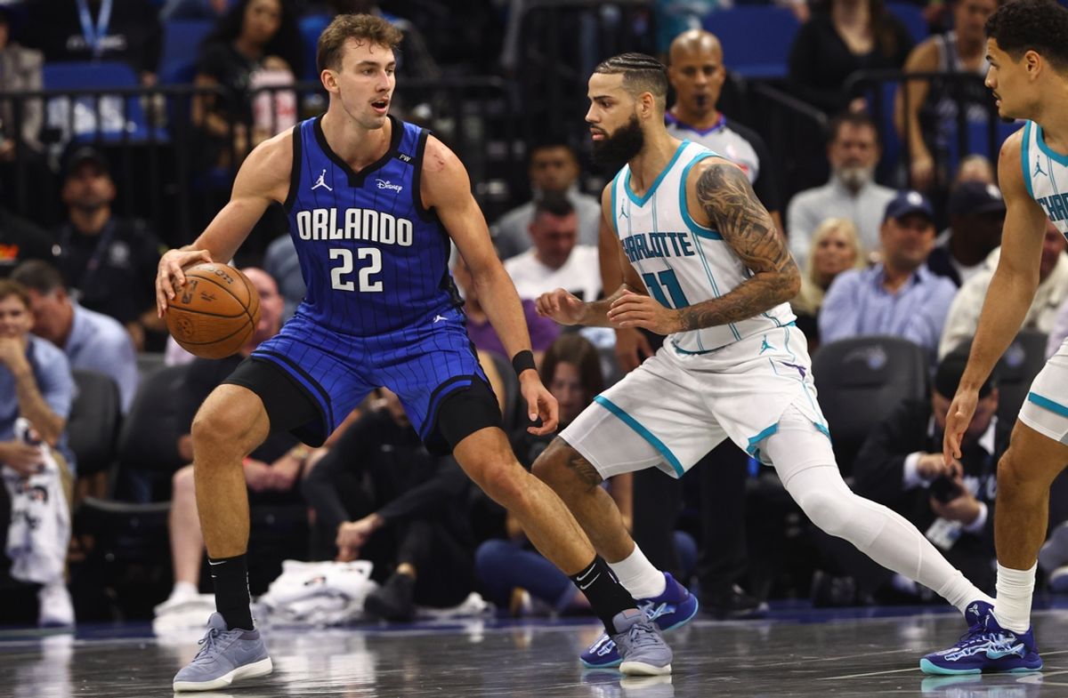 Nov 12, 2024; Orlando, Florida, USA; Orlando Magic forward Franz Wagner (22) drives to the basket as Charlotte Hornets forward Cody Martin (11) defends during the second quarter at Kia Center. Mandatory Credit: Kim Klement Neitzel-Imagn Images