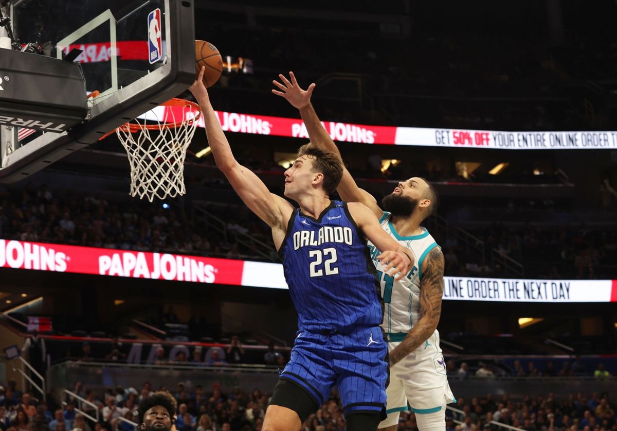 Nov 12, 2024; Orlando, Florida, USA; Orlando Magic forward Franz Wagner (22) shoots as Charlotte Hornets forward Cody Martin (11) defends  during the second half at Kia Center. Mandatory Credit: Kim Klement Neitzel-Imagn Images