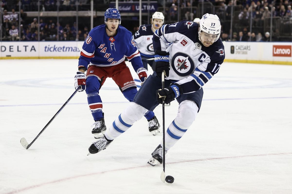 Nov 12, 2024; New York, New York, USA;  Winnipeg Jets center Adam Lowry (17) controls the puck in the third period against the New York Rangers at Madison Square Garden. Mandatory Credit: Wendell Cruz-Imagn Images