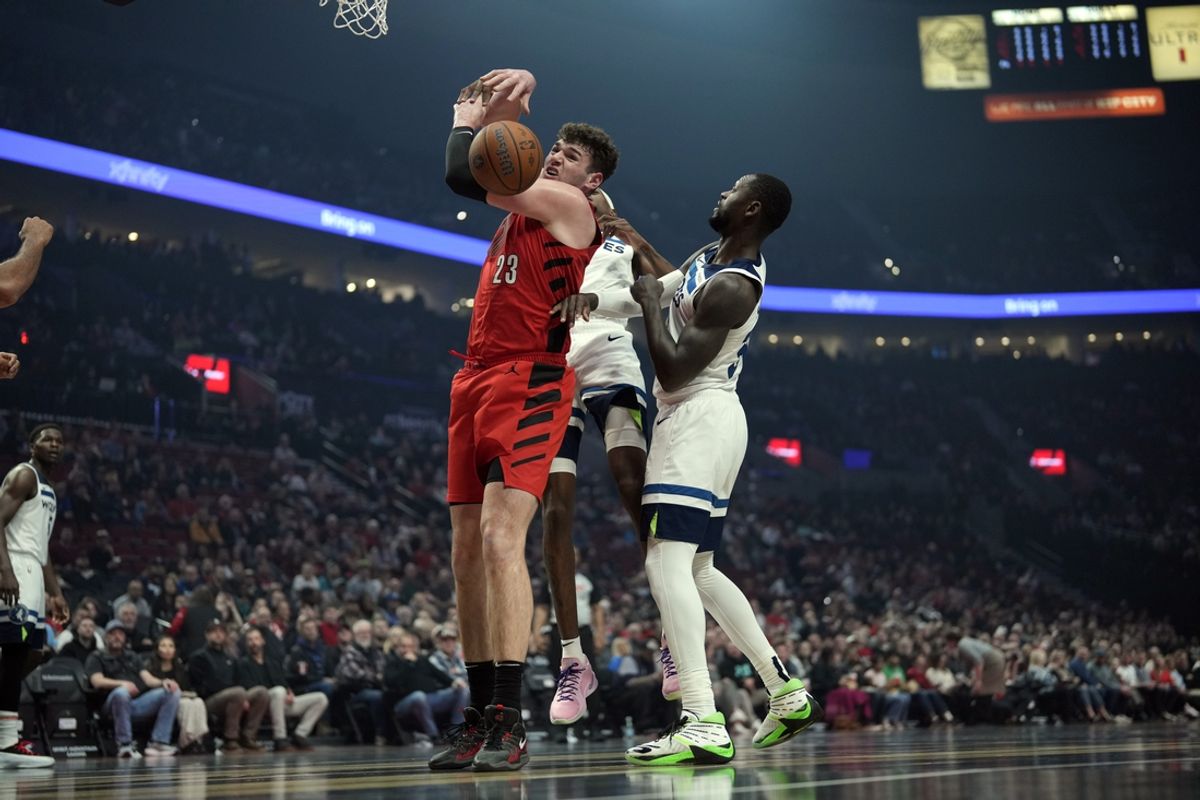 Nov 12, 2024; Portland, Oregon, USA; Portland Trail Blazers center Donovan Clingan (23) and Minnesota Timberwolves power forward Julius Randle (30, right) battle for a rebound during the first half at Moda Center. Mandatory Credit: Soobum Im-Imagn Images