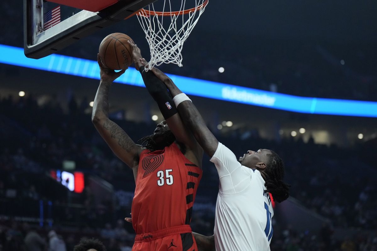 Nov 12, 2024; Portland, Oregon, USA; Portland Trail Blazers center Robert Williams III (35) shoots the ball against Minnesota Timberwolves center Naz Reid (11) during the first half at Moda Center. Mandatory Credit: Soobum Im-Imagn Images