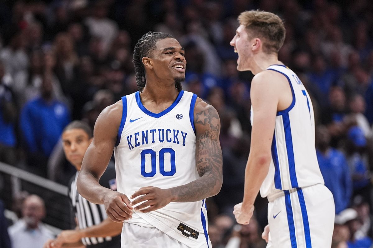 Nov 12, 2024; Atlanta, Georgia, USA; Kentucky Wildcats guard Otega Oweh (00) reacts with forward Andrew Carr (7) against the Duke Blue Devils during the second half at State Farm Arena. Mandatory Credit: Dale Zanine-Imagn Images