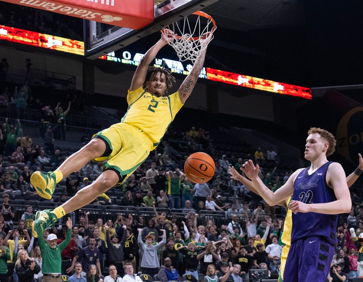 Oregon’s Jadrian Tracey dunks the ball over Portland’s Austin Rapp in overtime at Matthew Knight Arena.