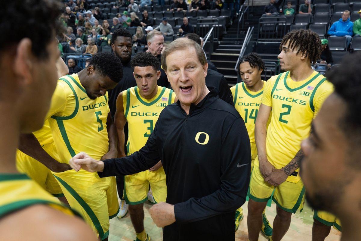 Oregon coach Dana Altman brings his team together before their game against Portland at Matthew Knight Arena.
