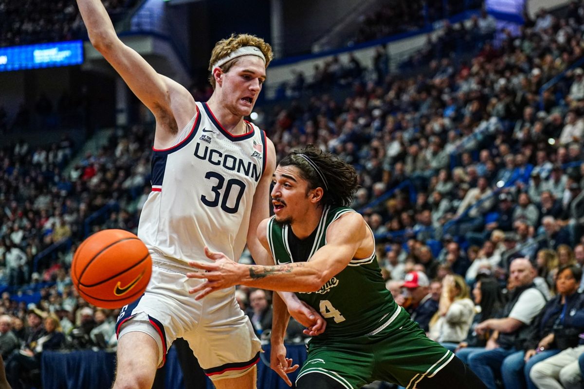Nov 13, 2024; Storrs, Connecticut, USA; UConn Huskies forward Liam McNeeley (30) defends against Le Moyne Dolphins guard Zek Tekin (4) in the first half at Harry A. Gampel Pavilion. Mandatory Credit: David Butler II-Imagn Images