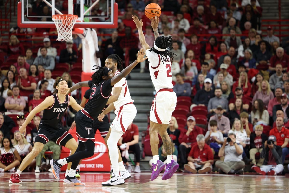 Nov 13, 2024; Fayetteville, Arkansas, USA; Arkansas Razorbacks guard Boogie Fland (2) shoots a three point shot in the first half defended by Troy Trojans guard Marcus Rigsby Jr. (2) at Bud Walton Arena. Mandatory Credit: Nelson Chenault-Imagn Images