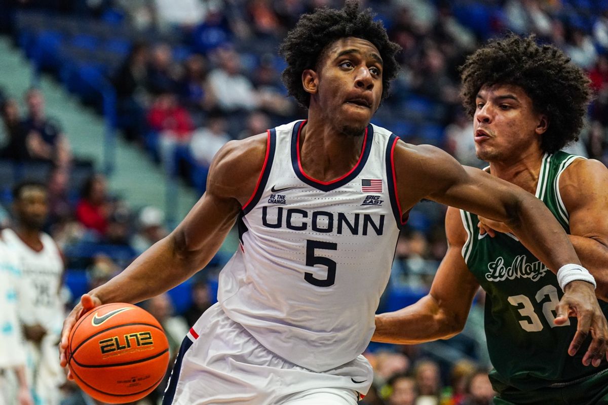 Nov 13, 2024; Storrs, Connecticut, USA; UConn Huskies center Tarris Reed Jr. (5) drives the ball against Le Moyne Dolphins forward Isaac Nyakundi (32)in the second half at Harry A. Gampel Pavilion. Mandatory Credit: David Butler II-Imagn Images