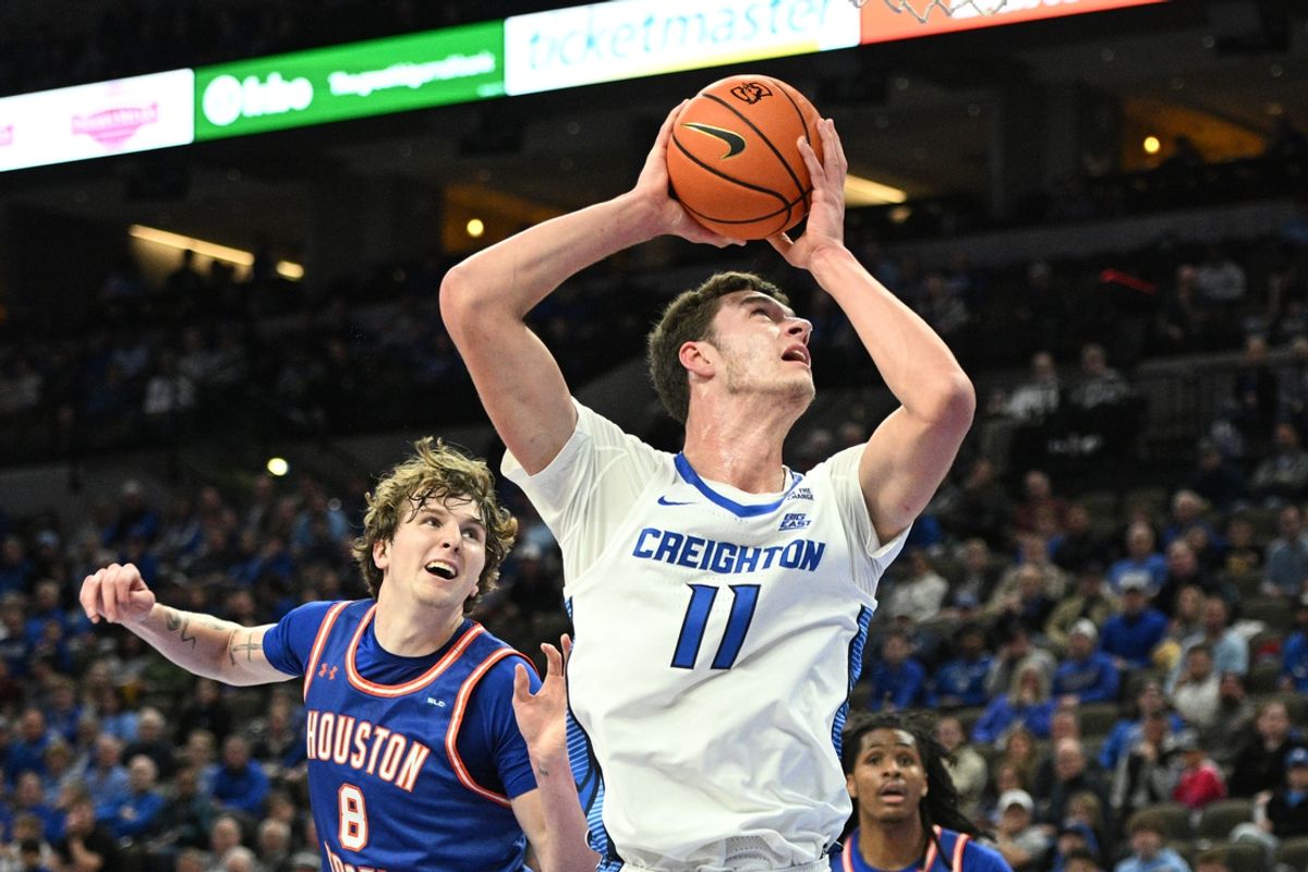 Nov 13, 2024; Omaha, Nebraska, USA;  Creighton Bluejays center Ryan Kalkbrenner (11) scores against Houston Christian Huskies forward Trent Johnson (8) during the first half at CHI Health Center Omaha. Mandatory Credit: Steven Branscombe-Imagn Images
