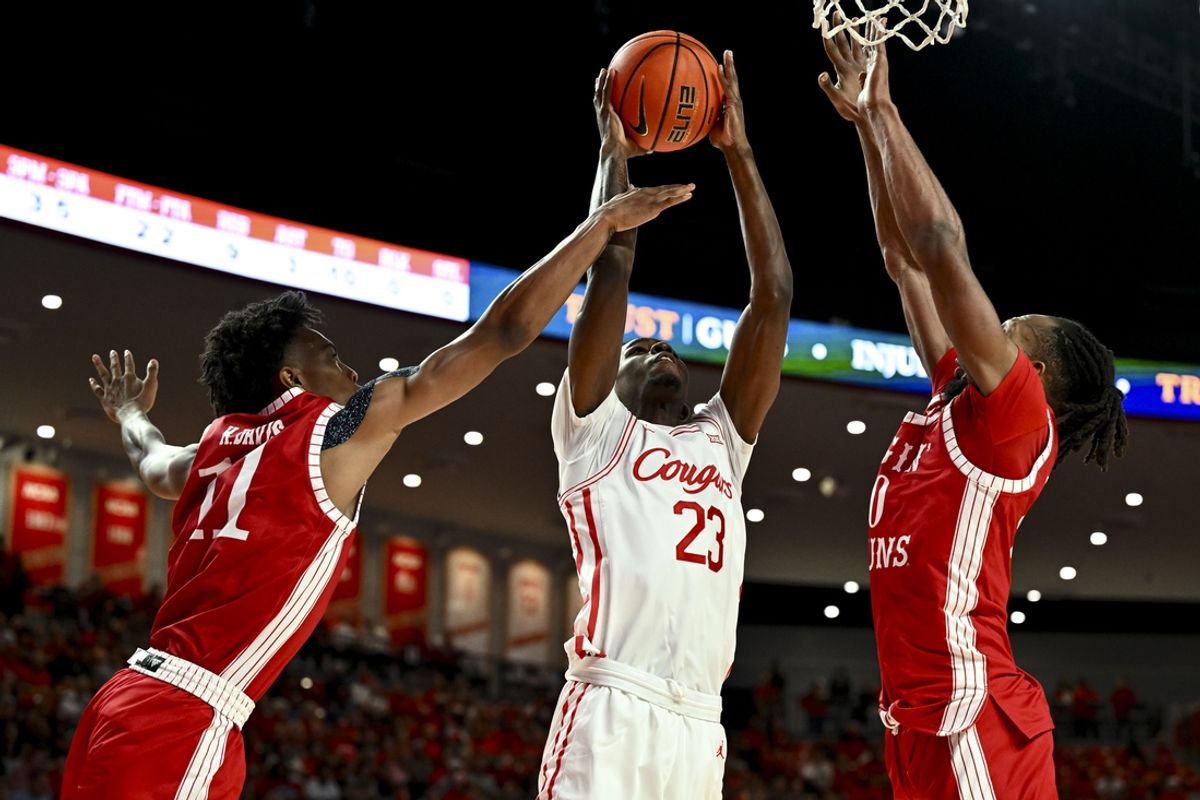 Nov 13, 2024; Houston, Texas, USA; Louisiana Ragin Cajuns guard Koron Davis (11) fouls Houston Cougars guard Terrance Arceneaux (23) during the first half at Fertitta Center. Mandatory Credit: Maria Lysaker-Imagn Images