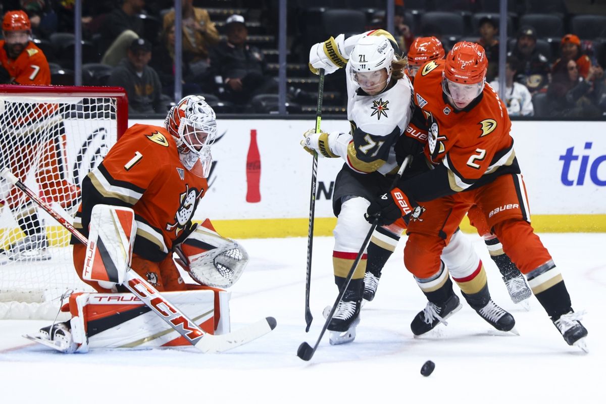 Nov 13, 2024; Anaheim, California, USA; Vegas Golden Knights center William Karlsson (71) battles for the puck against Anaheim Ducks defenseman Jackson LaCombe (2) during the first period of a hockey game at Honda Center. Mandatory Credit: Jessica Alcheh-Imagn Images