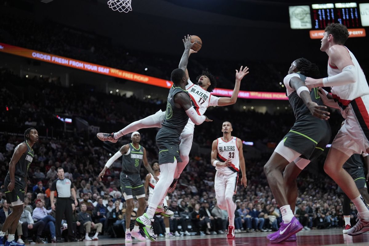 Nov 13, 2024; Portland, Oregon, USA; Portland Trail Blazers shooting guard Shaedon Sharpe (17) shoots the ball over Minnesota Timberwolves power forward Julius Randle (30) during the first half at Moda Center. Mandatory Credit: Soobum Im-Imagn Images