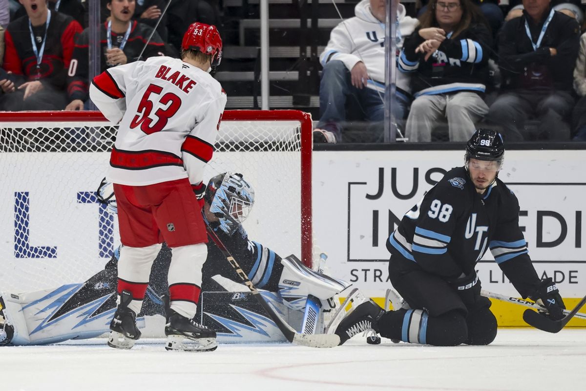Nov 13, 2024; Salt Lake City, Utah, USA; Utah Hockey Club goaltender Karel Vejmelka (70) deflects the puck from Carolina Hurricanes right wing Jackson Blake (53) during the second period at Delta Center. Mandatory Credit: Rob Gray-Imagn Images