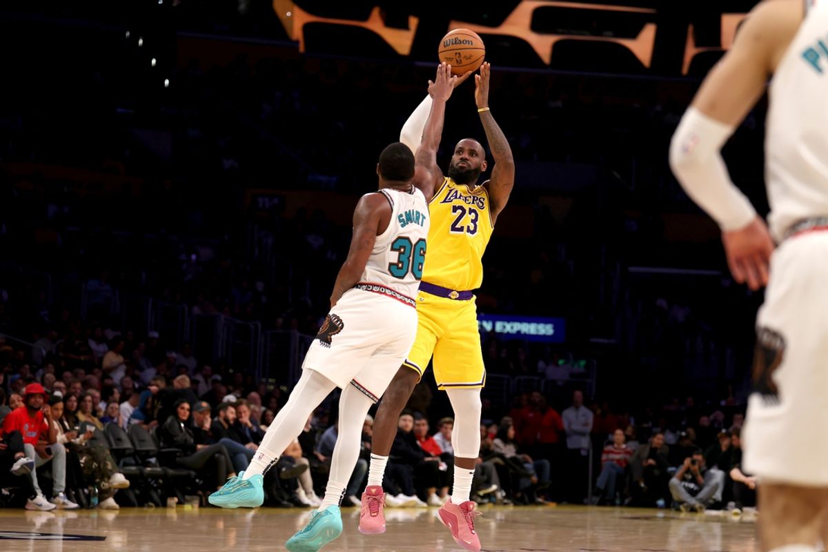 Nov 13, 2024; Los Angeles, California, USA;  Los Angeles Lakers forward LeBron James (23) shoots the ball over Memphis Grizzlies guard Marcus Smart (36) during the second quarter at Crypto.com Arena. Mandatory Credit: Kiyoshi Mio-Imagn Images