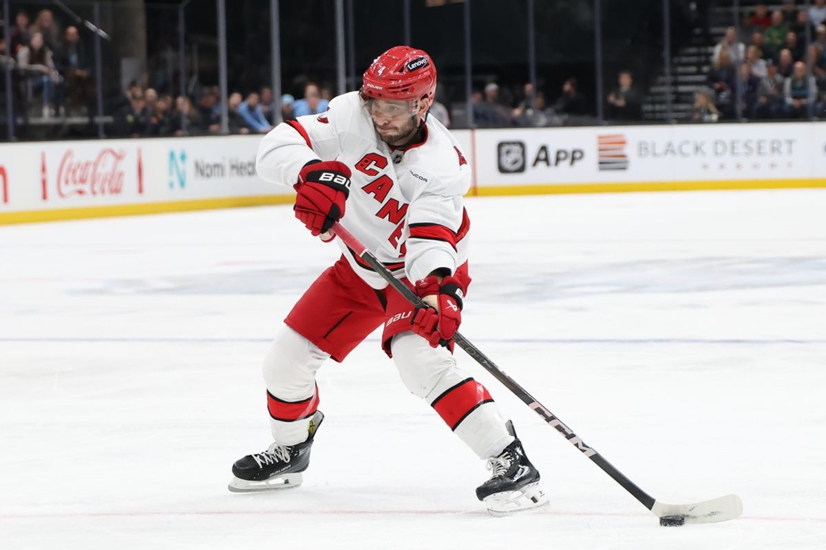 Nov 13, 2024; Salt Lake City, Utah, USA; Carolina Hurricanes defenseman Shayne Gostisbehere (4) takes a shot against the Utah Hockey Club during the third period at Delta Center. Mandatory Credit: Rob Gray-Imagn Images