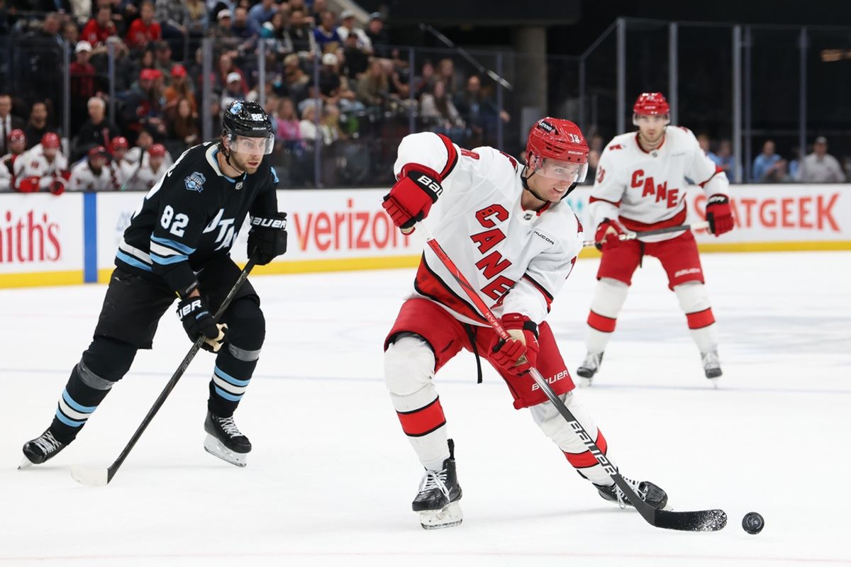 Nov 13, 2024; Salt Lake City, Utah, USA; Carolina Hurricanes center Jack Drury (18) passes the puck against the Utah Hockey Club during the third period at Delta Center. Mandatory Credit: Rob Gray-Imagn Images