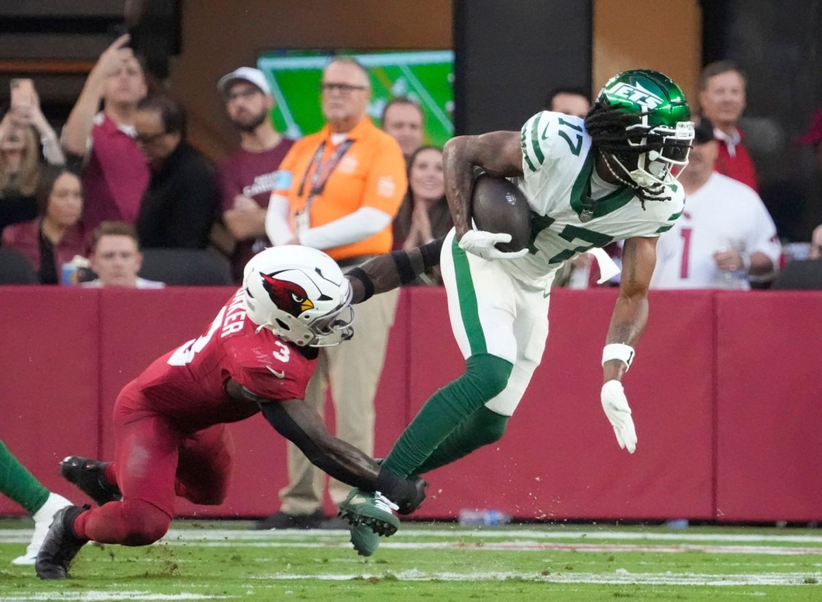 New York Jets wide receiver Davante Adams (17) is tackled by Arizona Cardinals safety Budda Baker (3) during the fourth quarter at State Farm Stadium in Glendale on Nov. 10, 2024.