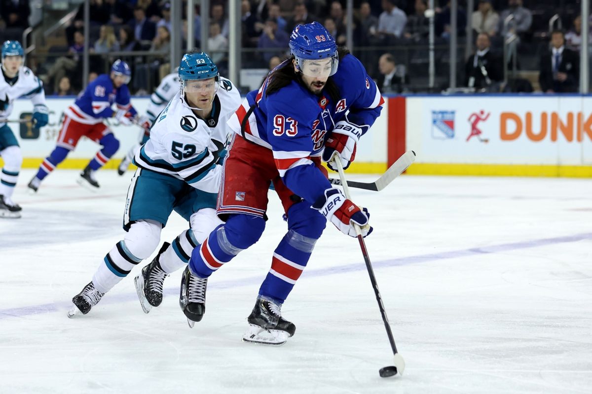 Nov 14, 2024; New York, New York, USA; New York Rangers center Mika Zibanejad (93) brings the puck up ice against San Jose Sharks center Ty Dellandrea (53) during the first period at Madison Square Garden. Mandatory Credit: Brad Penner-Imagn Images
