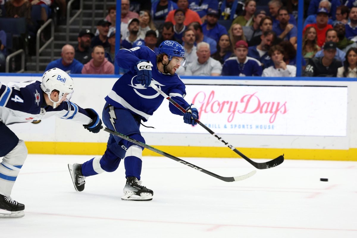 Nov 14, 2024; Tampa, Florida, USA; Tampa Bay Lightning left wing Brandon Hagel (38) shoots as Winnipeg Jets defenseman Neal Pionk (4) defends during the first period at Amalie Arena. Mandatory Credit: Kim Klement Neitzel-Imagn Images