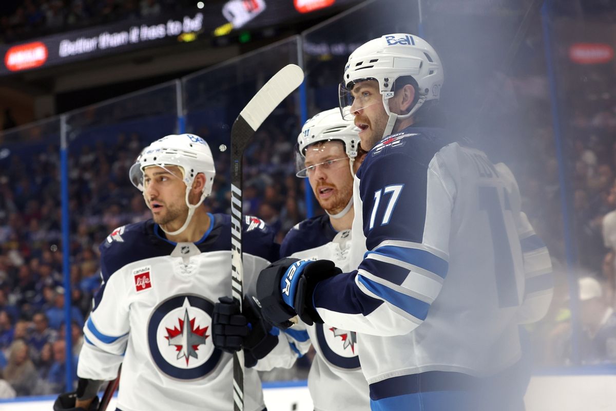 Nov 14, 2024; Tampa, Florida, USA;Winnipeg Jets center Adam Lowry (17) is congratulated  after he scored a goal against the Tampa Bay Lightning during the second period at Amalie Arena. Mandatory Credit: Kim Klement Neitzel-Imagn Images