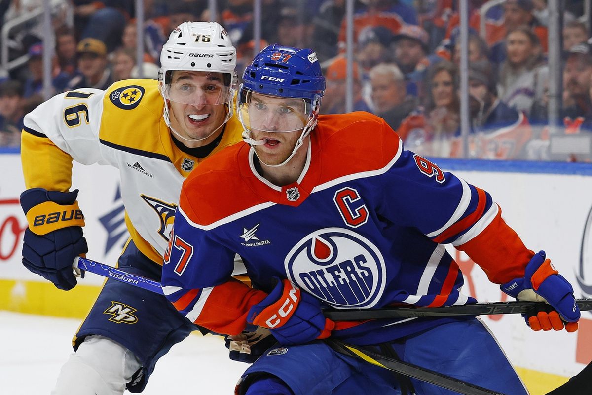 Nov 14, 2024; Edmonton, Alberta, CAN; Edmonton Oilers /forward Connor McDavid (97) and Nashville Predators defensemen Brady Skjei (76) battles for position during the first period at Rogers Place. Mandatory Credit: Perry Nelson-Imagn Images