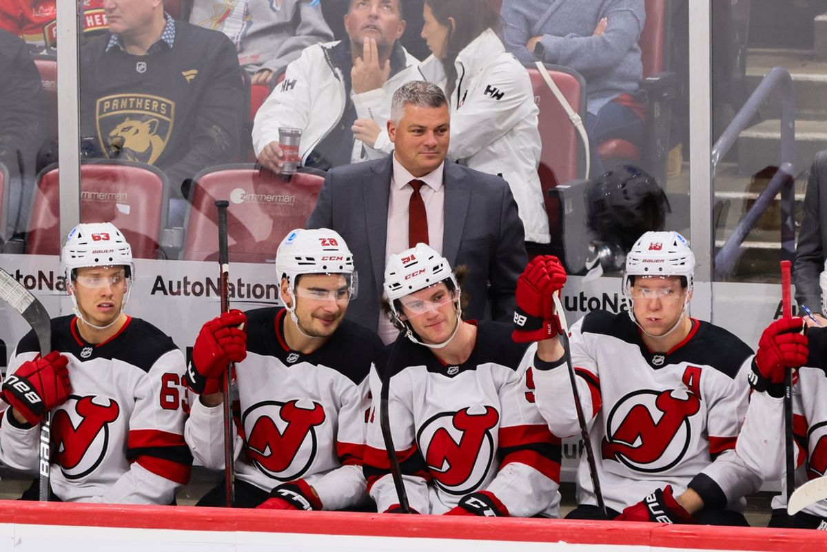 Nov 14, 2024; Sunrise, Florida, USA; New Jersey Devils head coach Sheldon Keefe watches from the bench against the Florida Panthers during the third period at Amerant Bank Arena. Mandatory Credit: Sam Navarro-Imagn Images