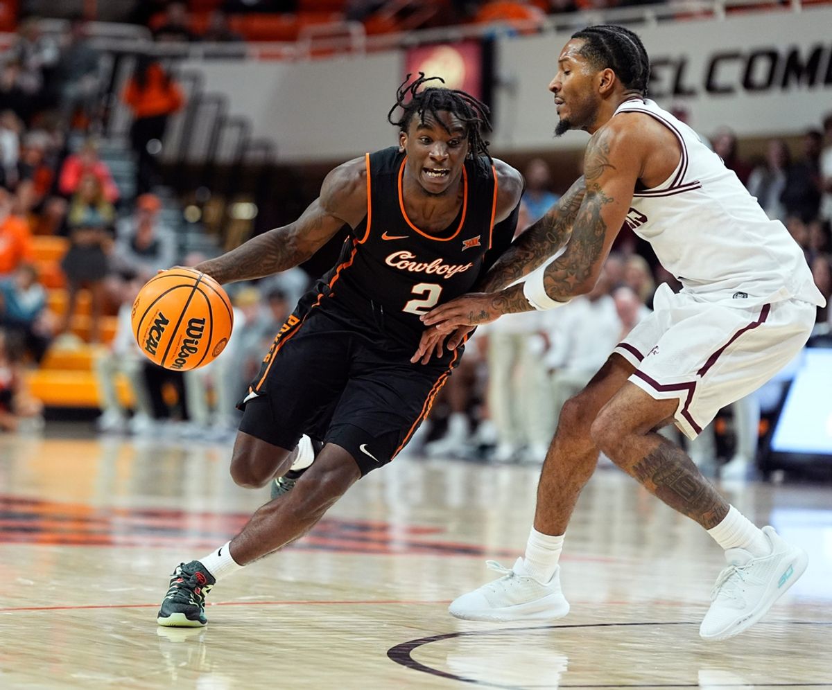 Oklahoma State's Arturo Dean (2) drives past Southern Illinois's Elijah Elliott (1) during the college basketball game between the Oklahoma State University Cowboys and the Southern Illinois Salukis, Thursday, Nov. 14, 2024.