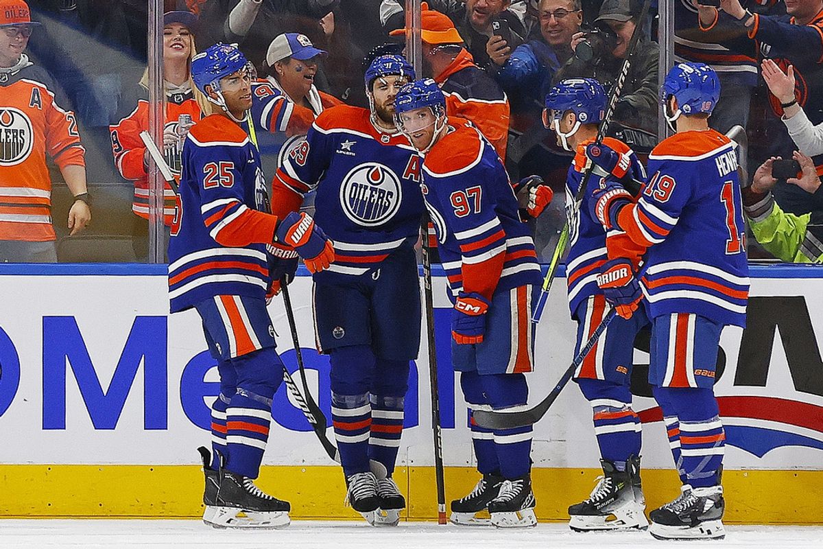 Nov 14, 2024; Edmonton, Alberta, CAN; Edmonton Oilers forward Connor McDavid (97) celebrates after scoring a goal during the second period, his 1000th NHL point against the Nashville Predators at Rogers Place. Mandatory Credit: Perry Nelson-Imagn Images
