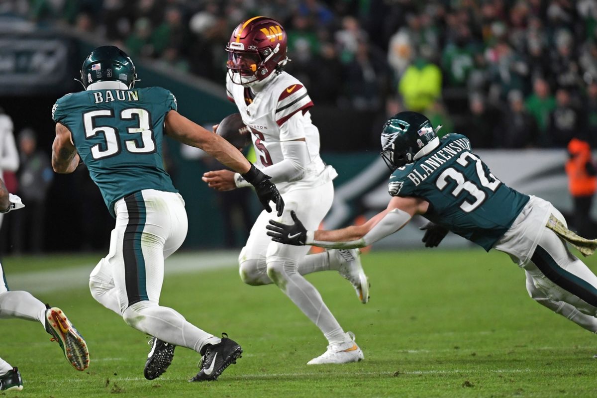 Nov 14, 2024; Philadelphia, Pennsylvania, USA; Washington Commanders quarterback Jayden Daniels (5) is chased boy Philadelphia Eagles linebacker Zack Baun (53) and safety Reed Blankenship (32) during the fourth quarter at Lincoln Financial Field. Mandatory Credit: Eric Hartline-Imagn Images