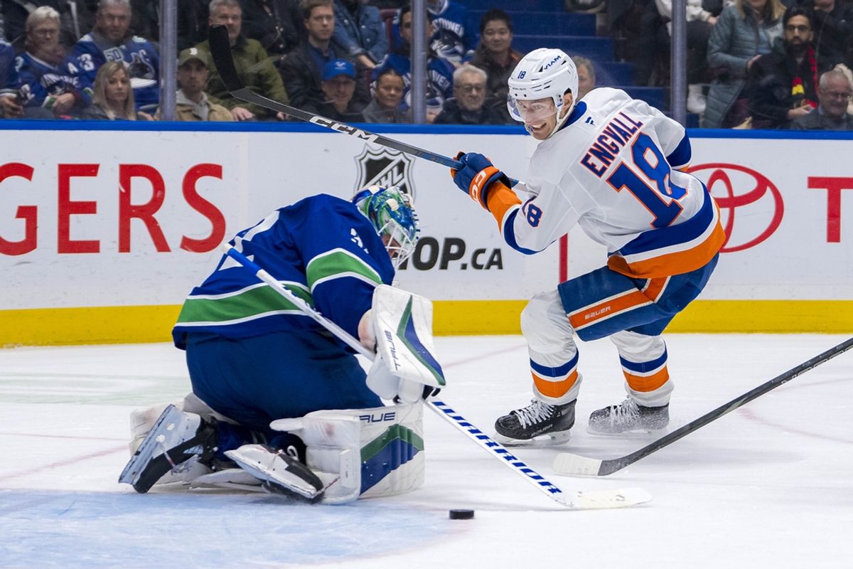 Nov 14, 2024; Vancouver, British Columbia, CAN; Vancouver Canucks goalie Kevin Lankinen (32) makes a save on New York Islanders forward Pierre Engvall (18) during the second period at Rogers Arena. Mandatory Credit: Bob Frid-Imagn Images