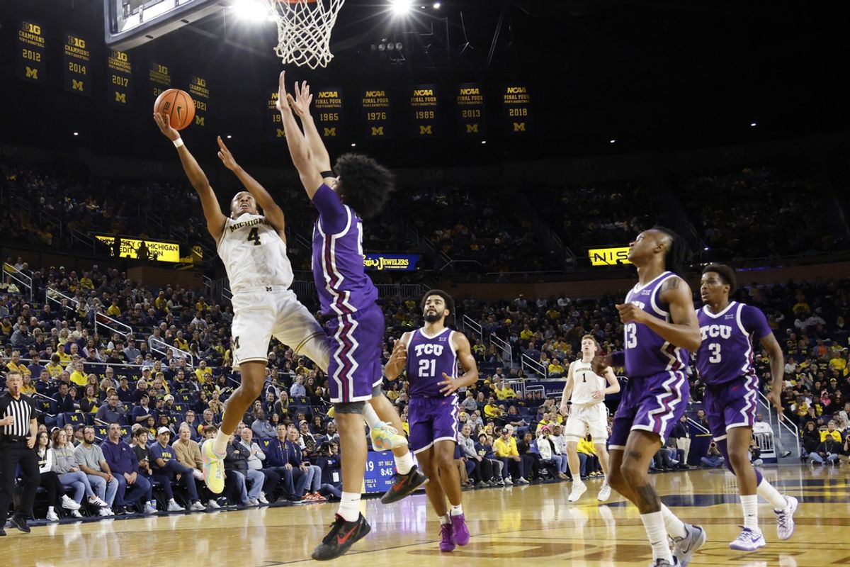 Nov 15, 2024; Ann Arbor, Michigan, USA;  Michigan Wolverines guard Nimari Burnett (4) shoots on TCU Horned Frogs forward David Punch (15) in the first half at Crisler Center. Mandatory Credit: Rick Osentoski-Imagn Images
