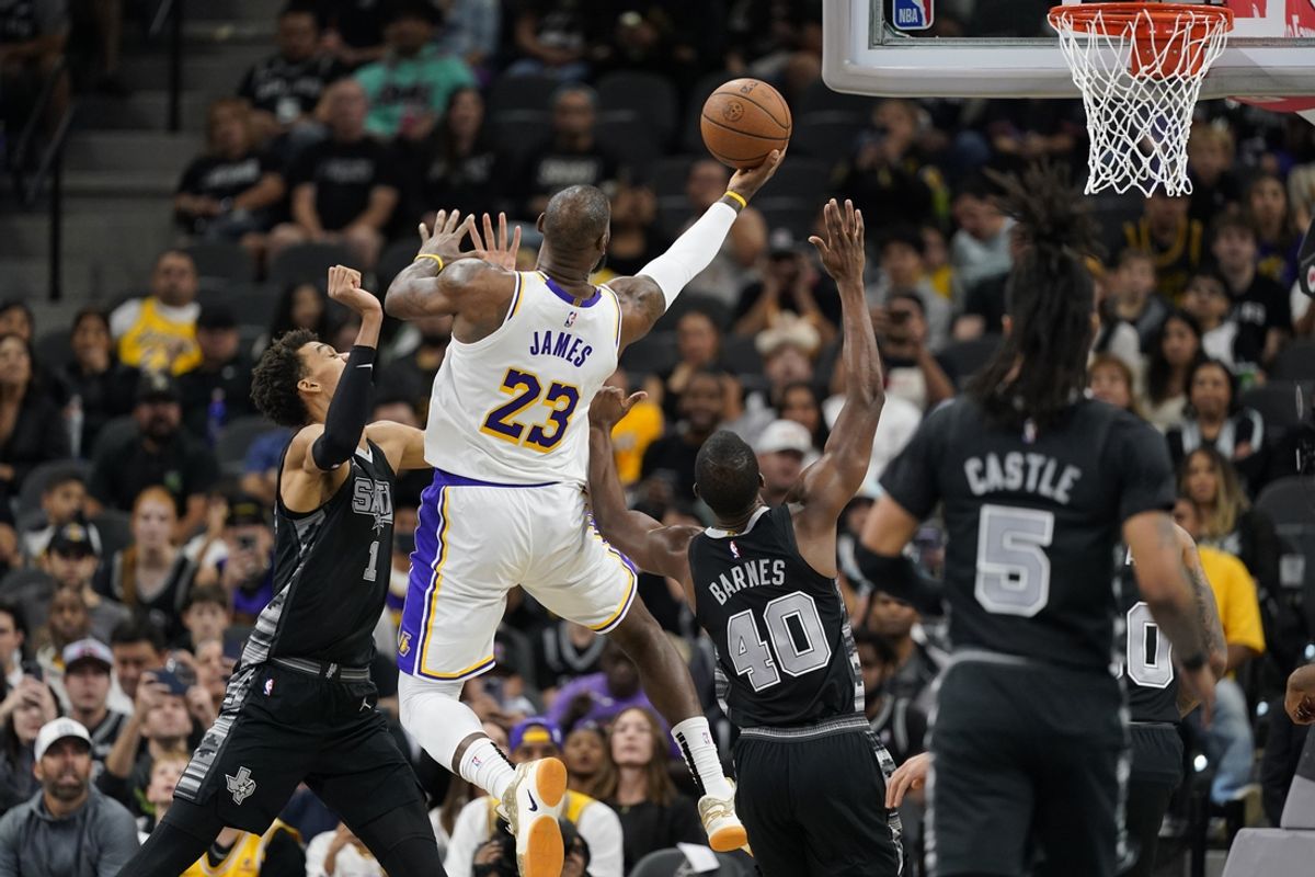 Nov 15, 2024; San Antonio, Texas, USA; Los Angeles Lakers forward LeBron James (23) drives to the basket while defended by San Antonio Spurs center Victor Wembanyama (1) and forward Harrison Barnes (40) during the first half at Frost Bank Center. Mandatory Credit: Scott Wachter-Imagn Images