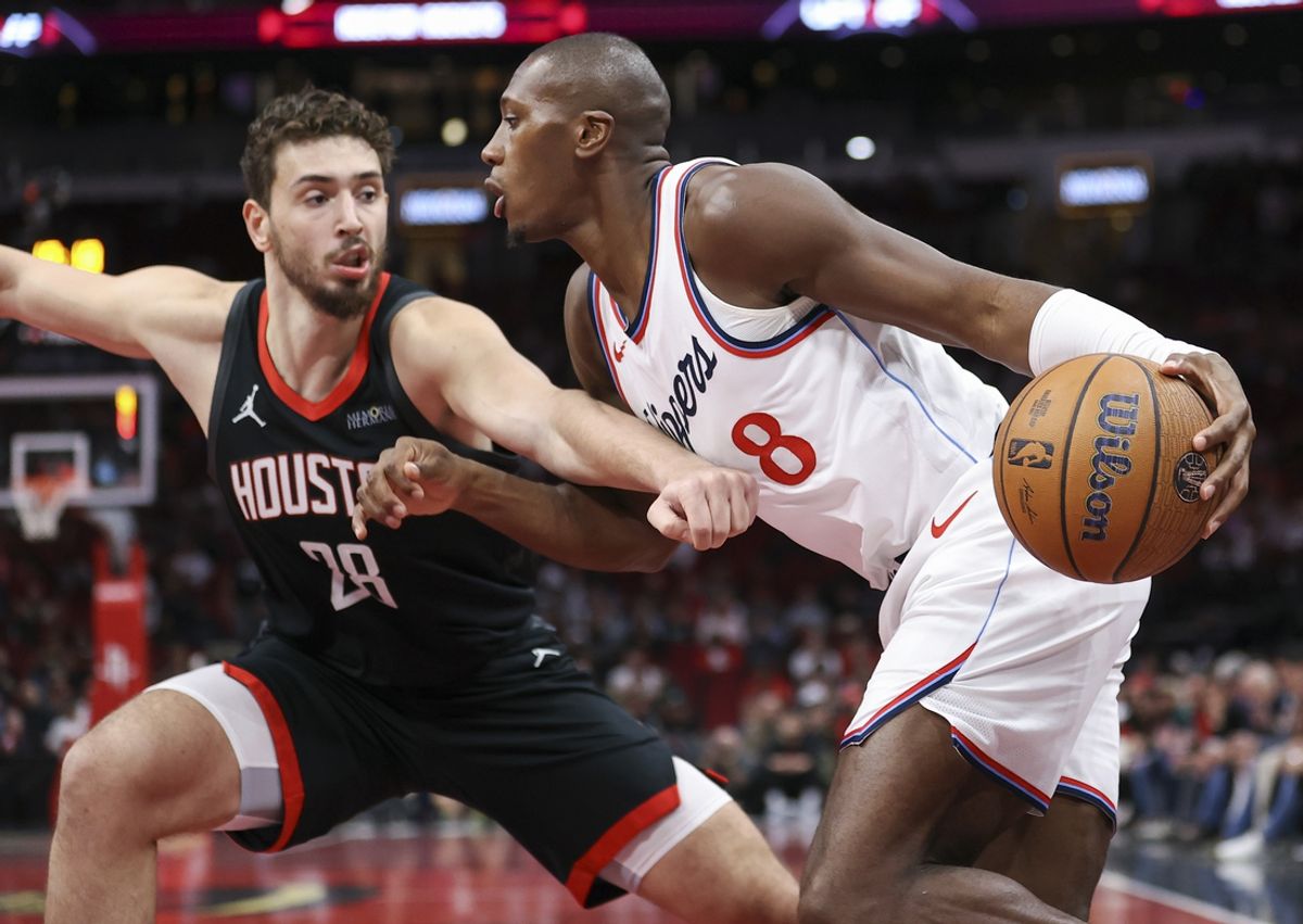 Nov 15, 2024; Houston, Texas, USA; Los Angeles Clippers guard Kris Dunn (8) drives with the ball as Houston Rockets center Alperen Sengun (28) defends during the first quarter at Toyota Center. Mandatory Credit: Troy Taormina-Imagn Images