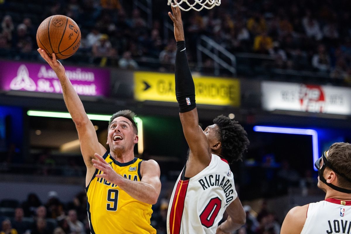 Nov 15, 2024; Indianapolis, Indiana, USA; Indiana Pacers guard T.J. McConnell (9) shoots the ball while Miami Heat guard Josh Richardson (0) defends in the first half at Gainbridge Fieldhouse. Mandatory Credit: Trevor Ruszkowski-Imagn Images