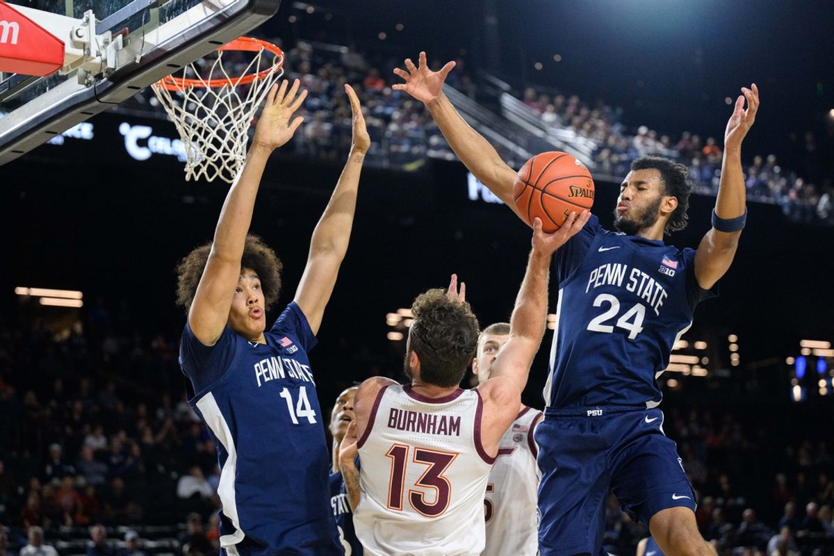 Nov 15, 2024; Baltimore, Maryland, USA; Virginia Tech Hokies forward Ben Burnham (13) shoots against Penn State Nittany Lions forward Zach Hicks (24) and forward Yanic Konan Niederhauser (14) during the first half at CFG Bank Arena. Mandatory Credit: Reggie Hildred-Imagn Images