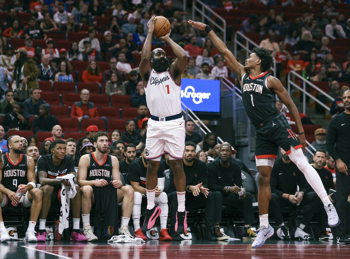 Nov 15, 2024; Houston, Texas, USA; Los Angeles Clippers guard James Harden (1) makes a three-point basket during the second quarter as Houston Rockets forward Amen Thompson (1) defends at Toyota Center. Mandatory Credit: Troy Taormina-Imagn Images