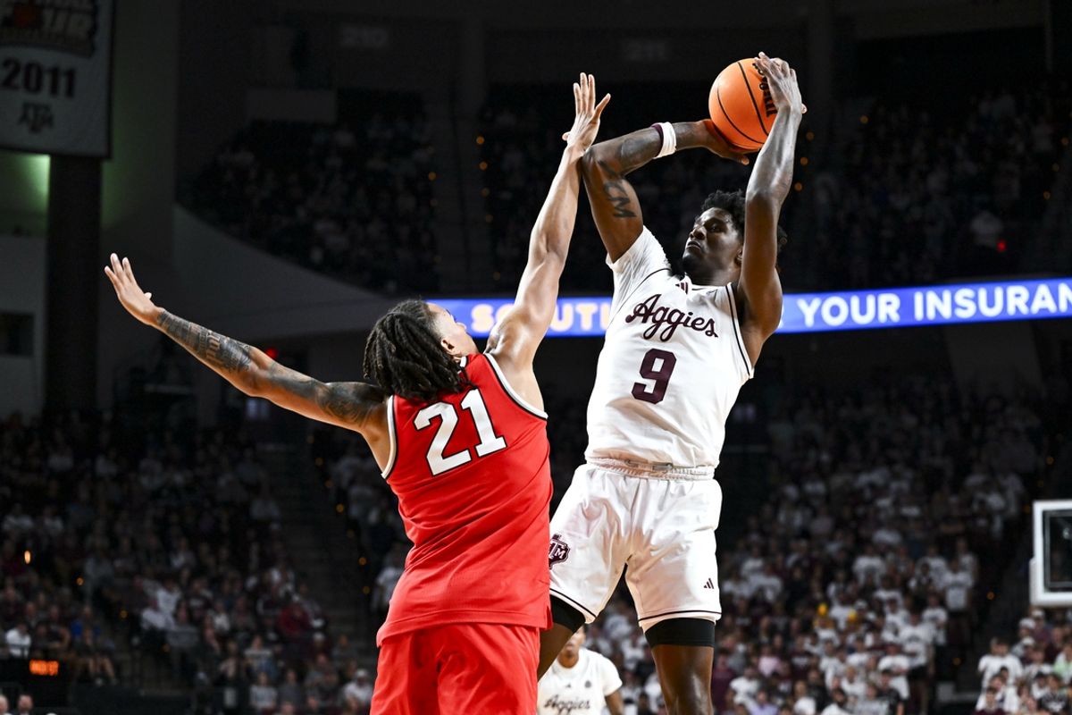 Nov 15, 2024; College Station, Texas, USA; Texas A&M Aggies forward Solomon Washington (9) shoots over Ohio State Buckeyes forward Devin Royal (21) during the first half at Reed Arena. Mandatory Credit: Maria Lysaker-Imagn Images