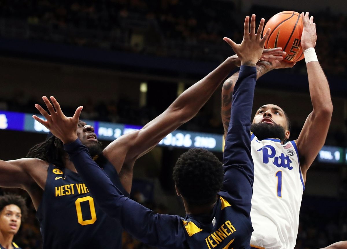 Nov 15, 2024; Pittsburgh, Pennsylvania, USA;  Pittsburgh Panthers guard Damian Dunn (1) shoots against West Virginia Mountaineers center Eduardo Andre (0) and guard KJ Tenner (3) during the second half at the Petersen Events Center. Mandatory Credit: Charles LeClaire-Imagn Images