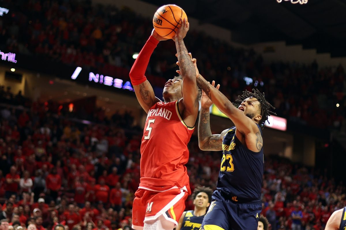Nov 15, 2024; College Park, Maryland, USA; Maryland Terrapins guard DeShawn Harris-Smith (5) takes a shot over Marquette Golden Eagles forward David Joplin (23) during the second half at Xfinity Center. Mandatory Credit: Daniel Kucin Jr.-Imagn Images