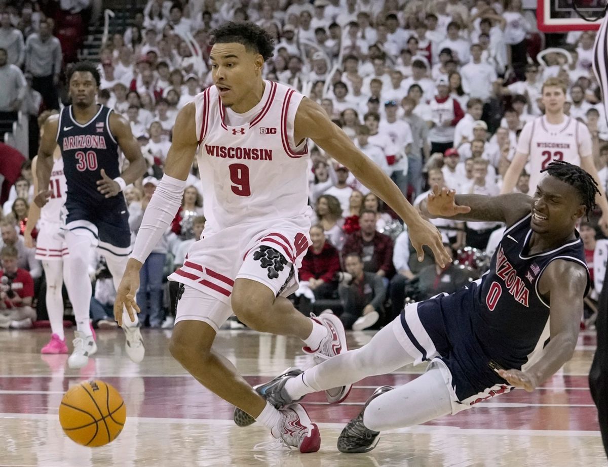 Arizona guard Jaden Bradley (0) fouls Wisconsin guard John Tonje (9) during the second half of their game Friday, November 15, 2024 at the Kohl Center in Madison, Wisconsin.