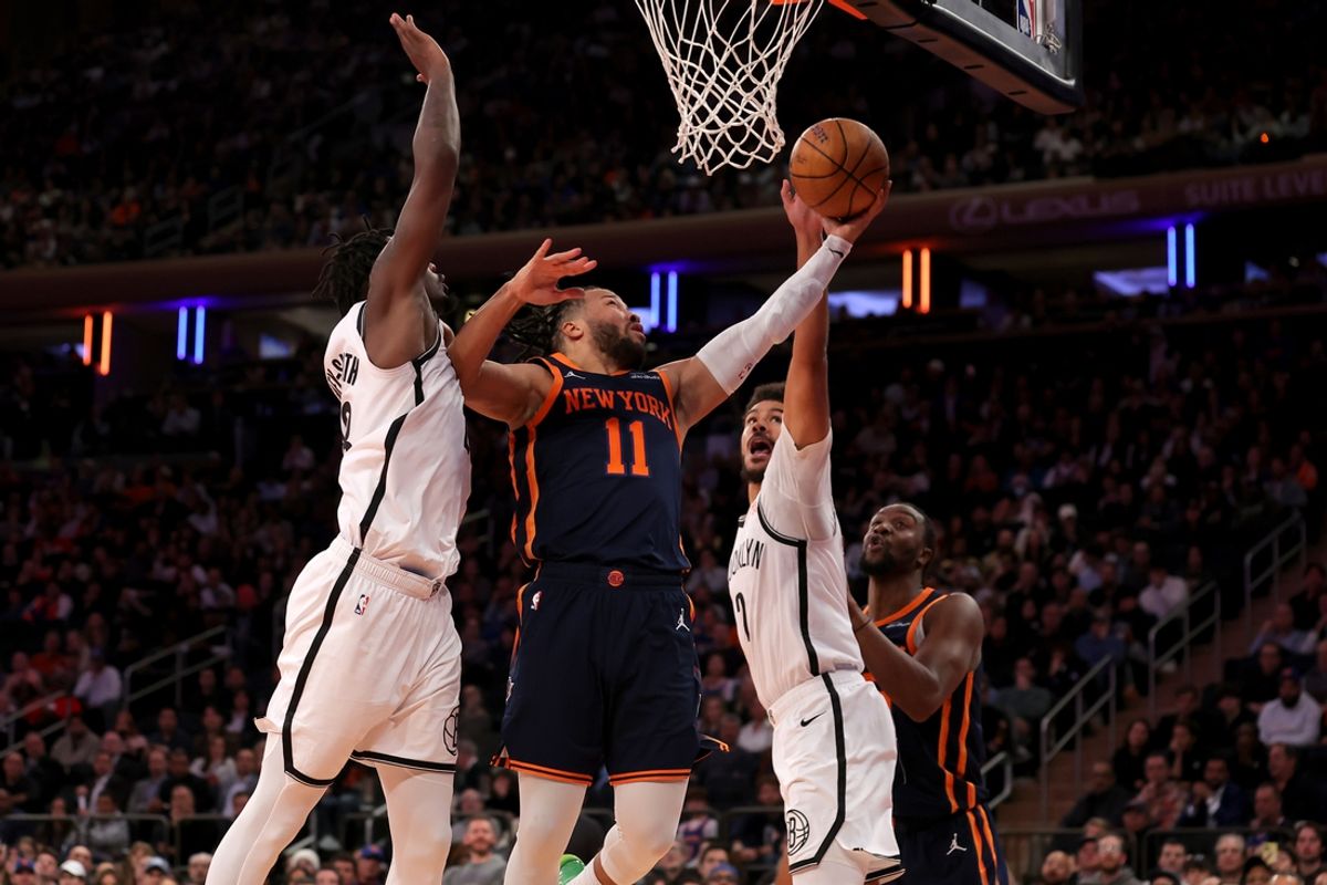 Nov 15, 2024; New York, New York, USA; New York Knicks guard Jalen Brunson (11) drives to the basket against Brooklyn Nets forwards Dorian Finney-Smith (28) and Cameron Johnson (2) during the fourth quarter at Madison Square Garden. Mandatory Credit: Brad Penner-Imagn Images
