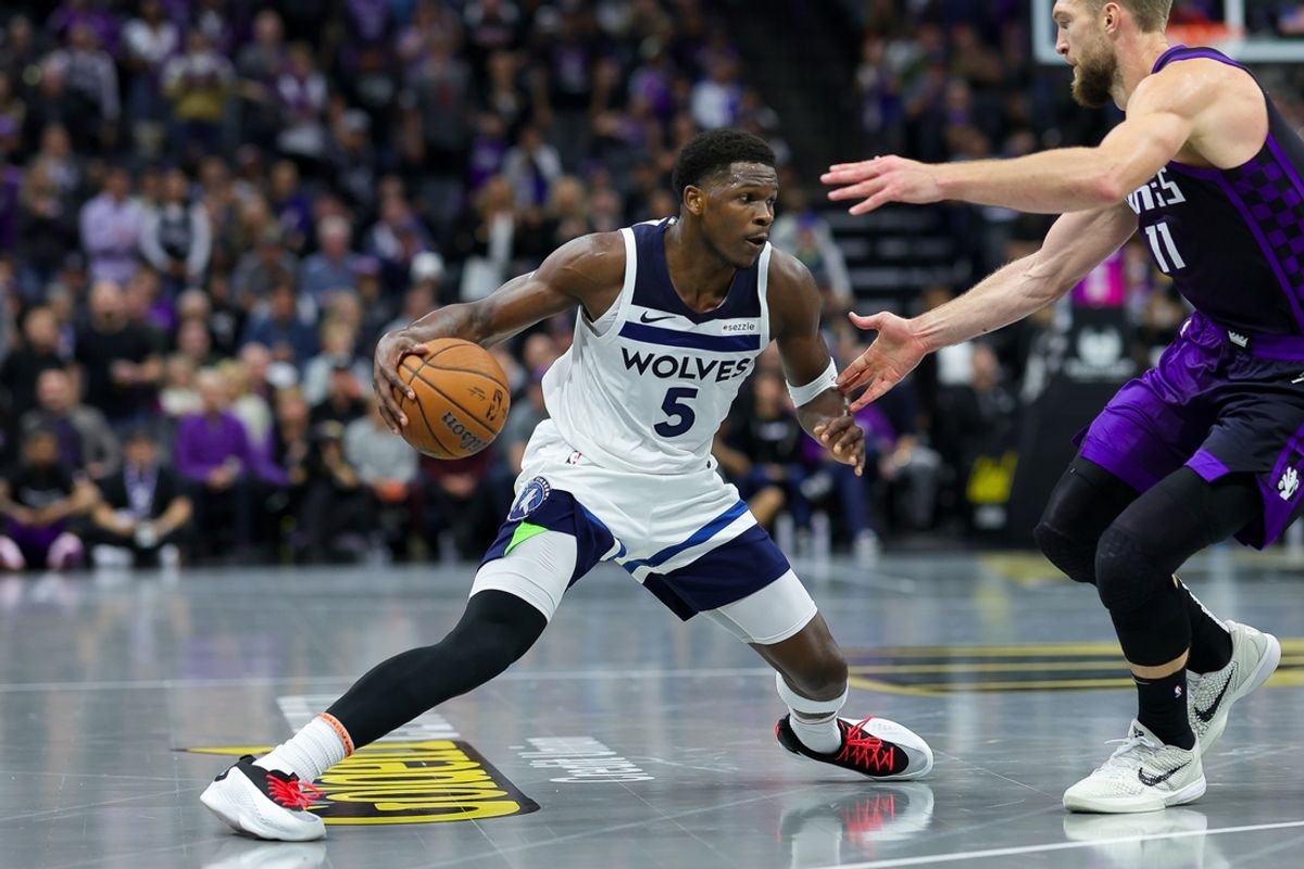 Nov 15, 2024; Sacramento, California, USA; Minnesota Timberwolves guard Anthony Edwards (5) dribbles the ball against Sacramento Kings forward Domantas Sabonis (11) during the fourth quarter at Golden 1 Center. Mandatory Credit: Sergio Estrada-Imagn Images