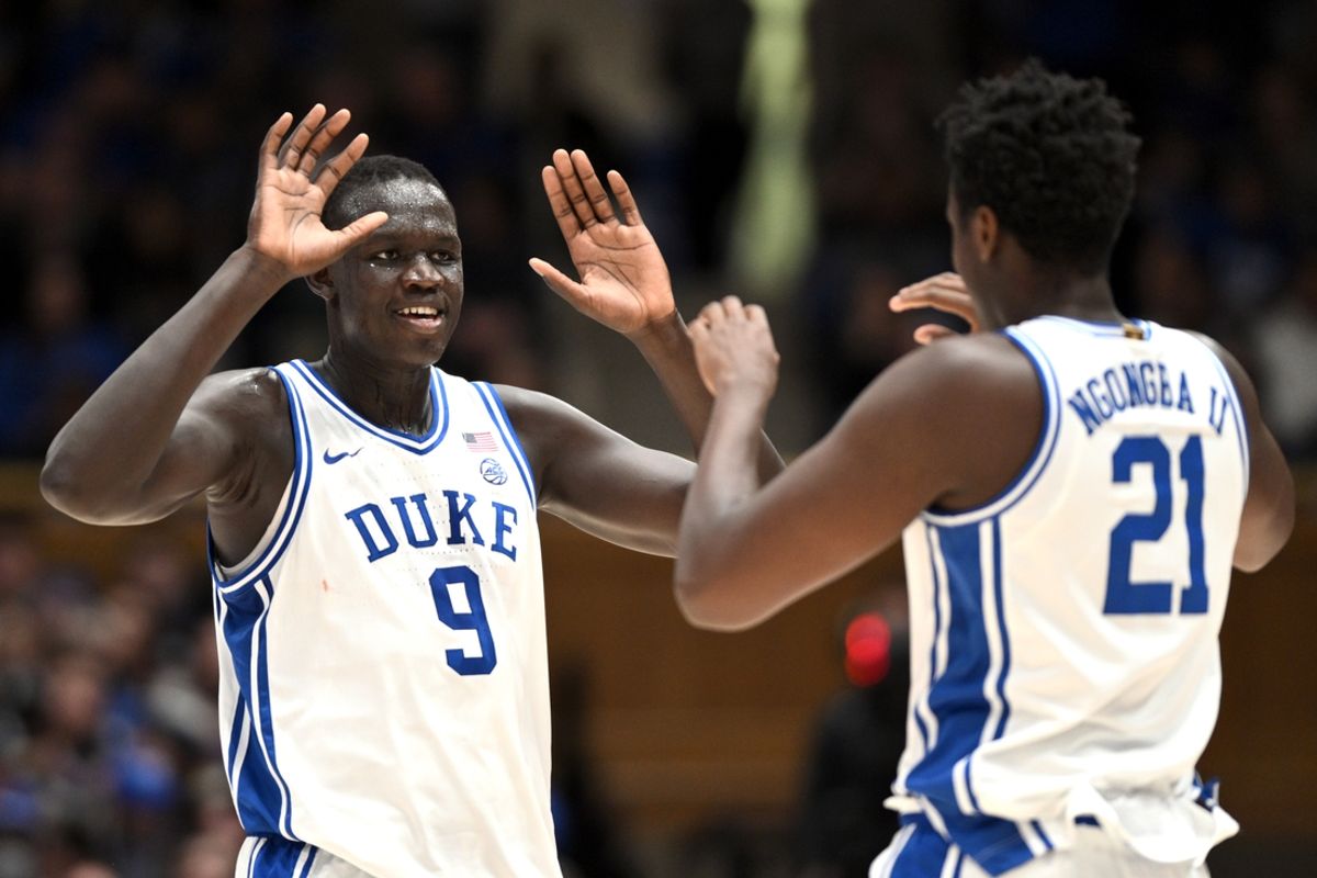Nov 16, 2024; Durham, North Carolina, USA; Duke Blue Devils center Khaman Maluach (9) welcomes center Patrick Ngongba II (21) to the court in the first half against the Wofford Terriers at Cameron Indoor Stadium. Mandatory Credit: Zachary Taft-Imagn Images