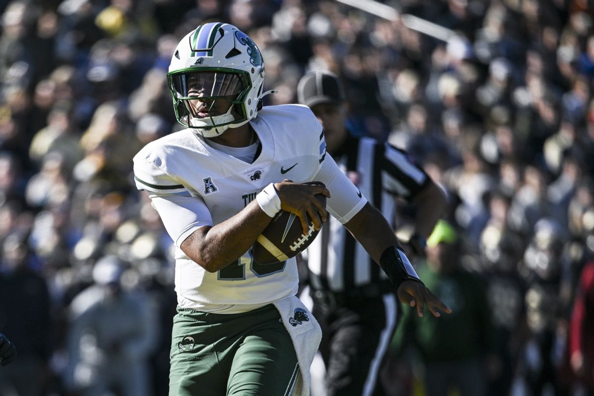 Nov 16, 2024; Annapolis, Maryland, USA;  Tulane Green Wave quarterback Darian Mensah (10) scores a touchdown during the first half against the Navy Midshipmen at Navy-Marine Corps Memorial Stadium. Mandatory Credit: Tommy Gilligan-Imagn Images