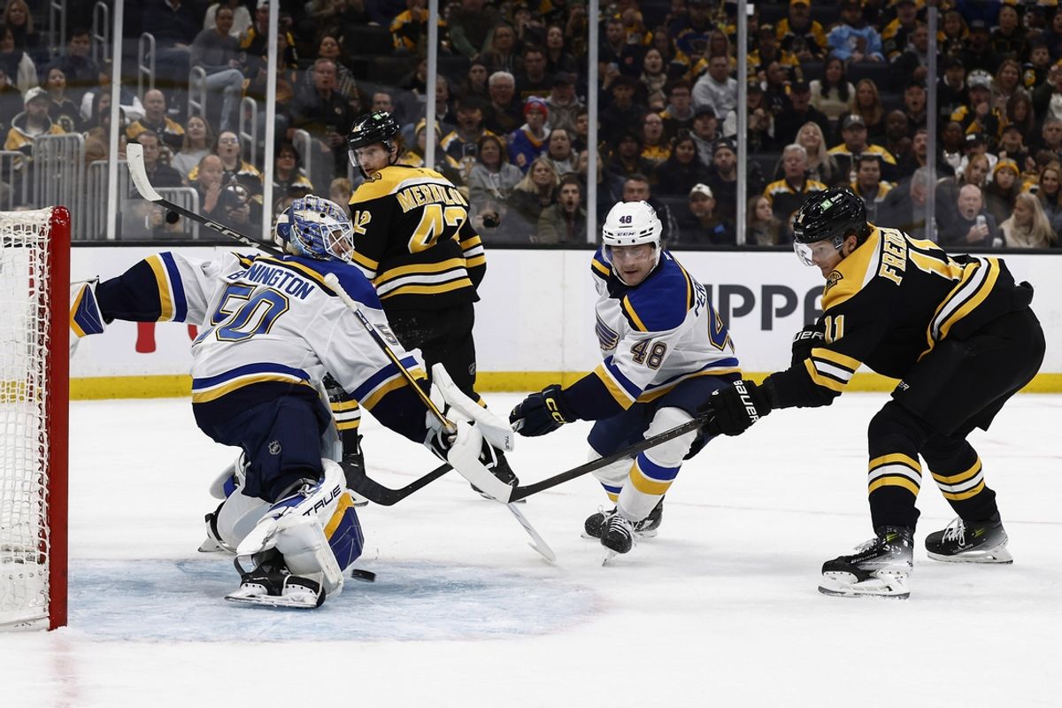 Nov 16, 2024; Boston, Massachusetts, USA; Boston Bruins center Trent Frederic (11) fires a shot past St. Louis Blues goaltender Jordan Binnington (50) for a goal during the first period at TD Garden. Mandatory Credit: Winslow Townson-Imagn Images