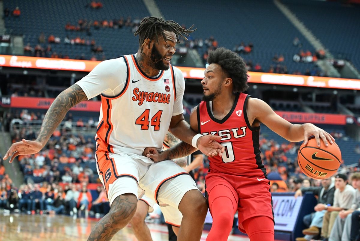 Nov 16, 2024; Syracuse, New York, USA; Youngstown State Penguins guard Jason Nelson (0) tries to drive the ball past Syracuse Orange center Eddie Lampkin Jr. (44) in the first half at the JMA Wireless Dome. Mandatory Credit: Mark Konezny-Imagn Images
