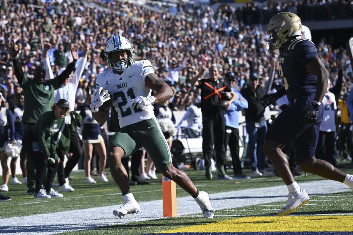 Nov 16, 2024; Annapolis, Maryland, USA; Tulane Green Wave running back Makhi Hughes (21) scores in front of Navy Midshipmen safety Kenneth McShan (0) during the second half  at Navy-Marine Corps Memorial Stadium. Mandatory Credit: Tommy Gilligan-Imagn Images